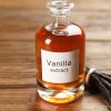 Aromatic vanilla extract and beans on wooden table